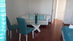 a dining room with a glass table and chairs at Emidio House in Termini