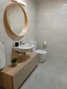 a bathroom with a sink and a toilet and a mirror at Ventura Apartment ESS02622 in San Sebastián