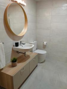 a bathroom with a sink and a toilet and a mirror at Ventura Apartment ESS02622 in Donostia-San Sebastián +22 photos