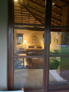 a view of a bedroom from a window of a room at Rancho de los Esteros in Colonia Carlos Pellegrini