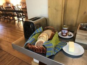 a basket of bread and butter on a table at The Squibb Houses in Cambria