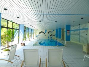 a room with a pool with a painting on the wall at Ferienwohnung 424 mit Hallenbad in Bad Reichenhall