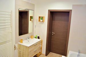 a bathroom with a sink and a mirror at Le temps d'un rêve, prestige, détente au centre ville. in Molsheim
