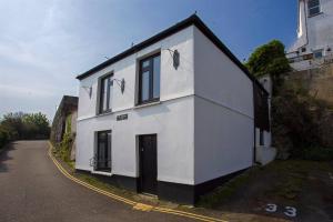 a white building on the side of a road at The Old Bakery in Falmouth