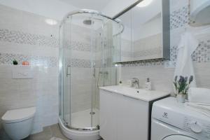 a bathroom with a shower and a toilet and a sink at Blaise in Trogir +45 photos