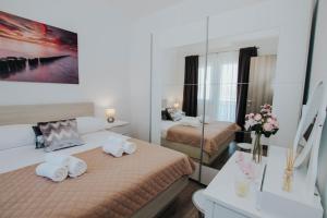 a hotel room with two beds and a mirror at Blaise in Trogir