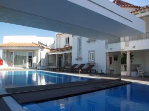 a swimming pool in the middle of a house at Quinta Do Molinu in Lourinhã