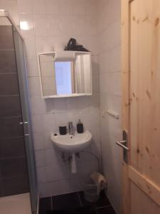 a small bathroom with a sink and a mirror at Apartmany Lend in Lend
