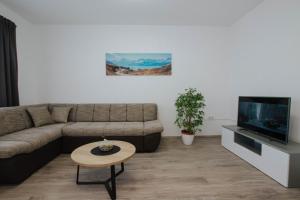 a living room with a couch and a tv at Blaise in Trogir