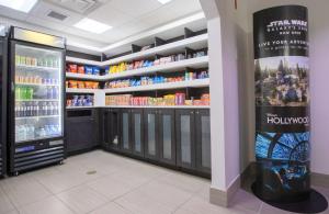 a store aisle with a drink cooler and shelves with drinks at Best Western Plus Orlando Lake Buena Vista South Inn & Suites in Kissimmee