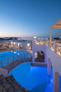 a view of a resort pool at night at Kanale's Rooms & Suites in Naousa