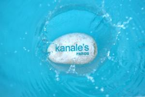 a rock in the water with the word karma on it at Kanale's Rooms & Suites in Naousa