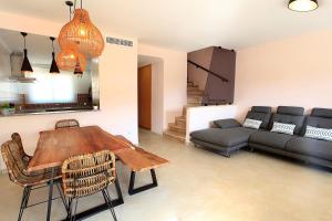 a living room with a table and a couch at Benestar In Jalon Valley in Alcalalí