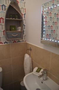 a bathroom with a sink and a toilet and a mirror at Hotel 50 in Bournemouth