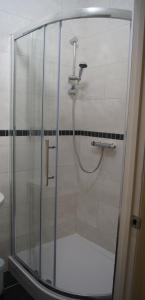 a shower with a glass door in a bathroom at Hotel 50 in Bournemouth
