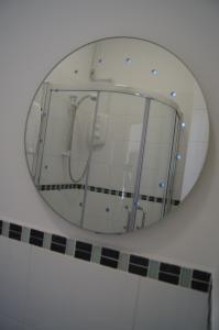 a mirror in a bathroom with a shower at Hotel 50 in Bournemouth