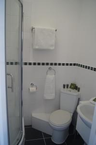 a white bathroom with a toilet and a sink at Hotel 50 in Bournemouth