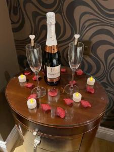 a table with two glasses and a bottle of wine at Halvard Hotel in Douglas
