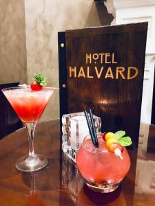 two cocktails on a table next to a hotel halvan sign at Halvard Hotel in Douglas