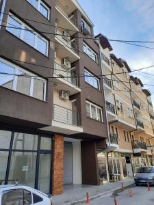 a tall building with a car parked in front of it at Apartments S*A in Ohrid