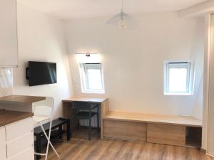 a room with two desks and a tv and a desk at Studio neuf et cosy au centre de Paris in Paris