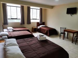 Una cama o camas en una habitación de Hostal Tambo Alto