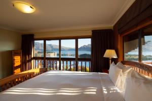 a bedroom with a bed with a view of the mountains at Matterhorn Lodge in Queenstown