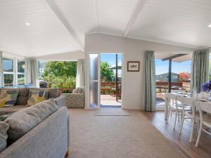 un soggiorno con divano e tavolo di Wharewaka Hideaway - Wharewaka Holiday Home a Taupo