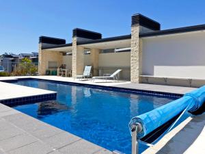 a pool with a water slide in front of a house at Marinaside Villa - Taupo Holiday Apartment in Taupo