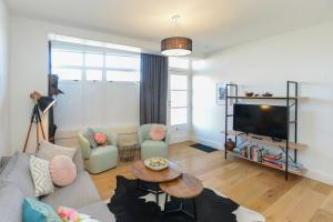 a living room with a couch and a table at Studio 488 - Napier Holiday Apartment in Napier