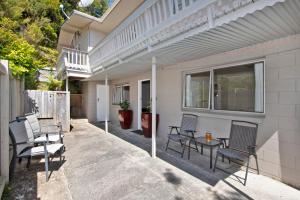 a patio with chairs and a table on a house at Camellia with WiFi - Paihia Unit in Paihia