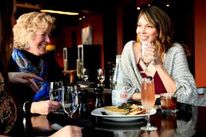 two women sitting at a table with a plate of food at The Peaks Resort and Spa in Telluride