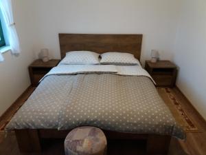 a bedroom with a large bed with two night stands at Kuća za odmor Cesarica in Marija Bistrica