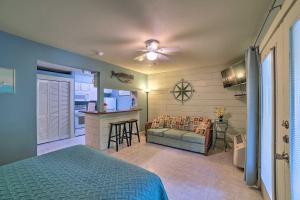 a bedroom with a bed and a couch and a kitchen at Coastal Studio with Amenities Walk to Padre Beach! in Corpus Christi