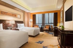 Säng eller sängar i ett rum på Wanda Realm Harbin Hotel