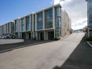 an empty parking lot in front of a building at Marinaside Villa - Taupo Holiday Apartment in Taupo