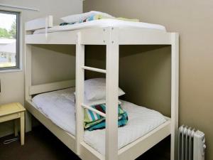a white bunk bed in a room at Harakeke House Upstairs - Ohakune Chalet in Ohakune