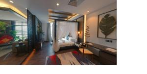 a bedroom with a bed and a desk in a room at Vangohh Eminent Hotel & Spa in Bukit Mertajam