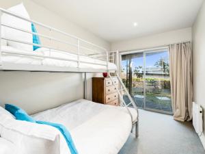 a bedroom with two bunk beds and a window at Lake Views on Yewlett - Queenstown Holiday Home in Queenstown