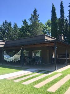 a house with a hammock in the front of it at la casa de los pájaros in San Pedro