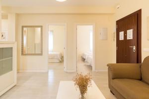 uma sala de estar com um sofá e uma mesa em Alferez I by ELE Apartments em Málaga