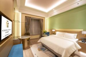 En eller flere senger på et rom på Metropolo Hotel-Guangzhou baiyunzhan jiangnan market canton fair phase free shuttle bus