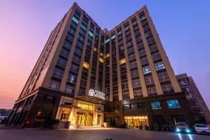 a large building with a lot of windows at Metropolo Jingjiang Hotels- JiangNan market ShuangLong in Guangzhou