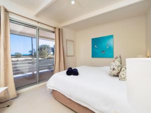 a bedroom with a bed and a large window at Seaview Getaway in Dunbogan
