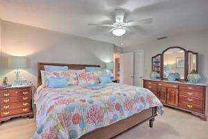 a bedroom with a bed and a dresser and a mirror at Single-Story Home Walk to Beach, Pier and River in Ormond Beach