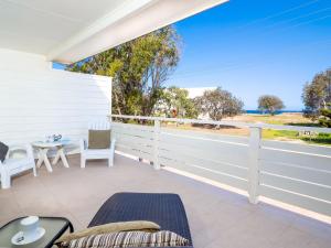 a patio with a table and chairs and a view of the ocean at Seaview Getaway in Dunbogan