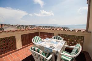 a patio with a table and chairs on a balcony at Apartment Kralj in Selce