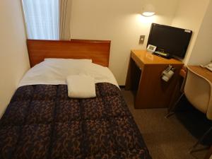 een hotelkamer met een bed en een flatscreen-tv bij Residence Hotel Will Shinjuku in Tokyo