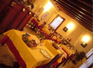 a dining room with a table with a yellow table cloth at Albergo La Meridiana in Portogruaro