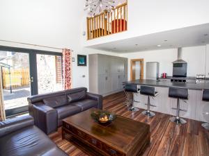 a living room with a couch and a table and a kitchen at Nef-Stedi in Kirktown of Bourtie